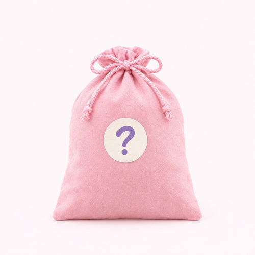 A pink gift bag with a question mark sticker, a mystery mofu inside